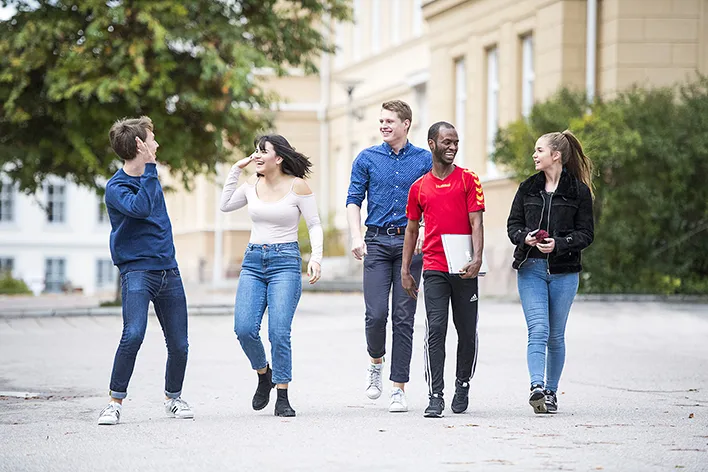 Group with teenagers smiling at each other