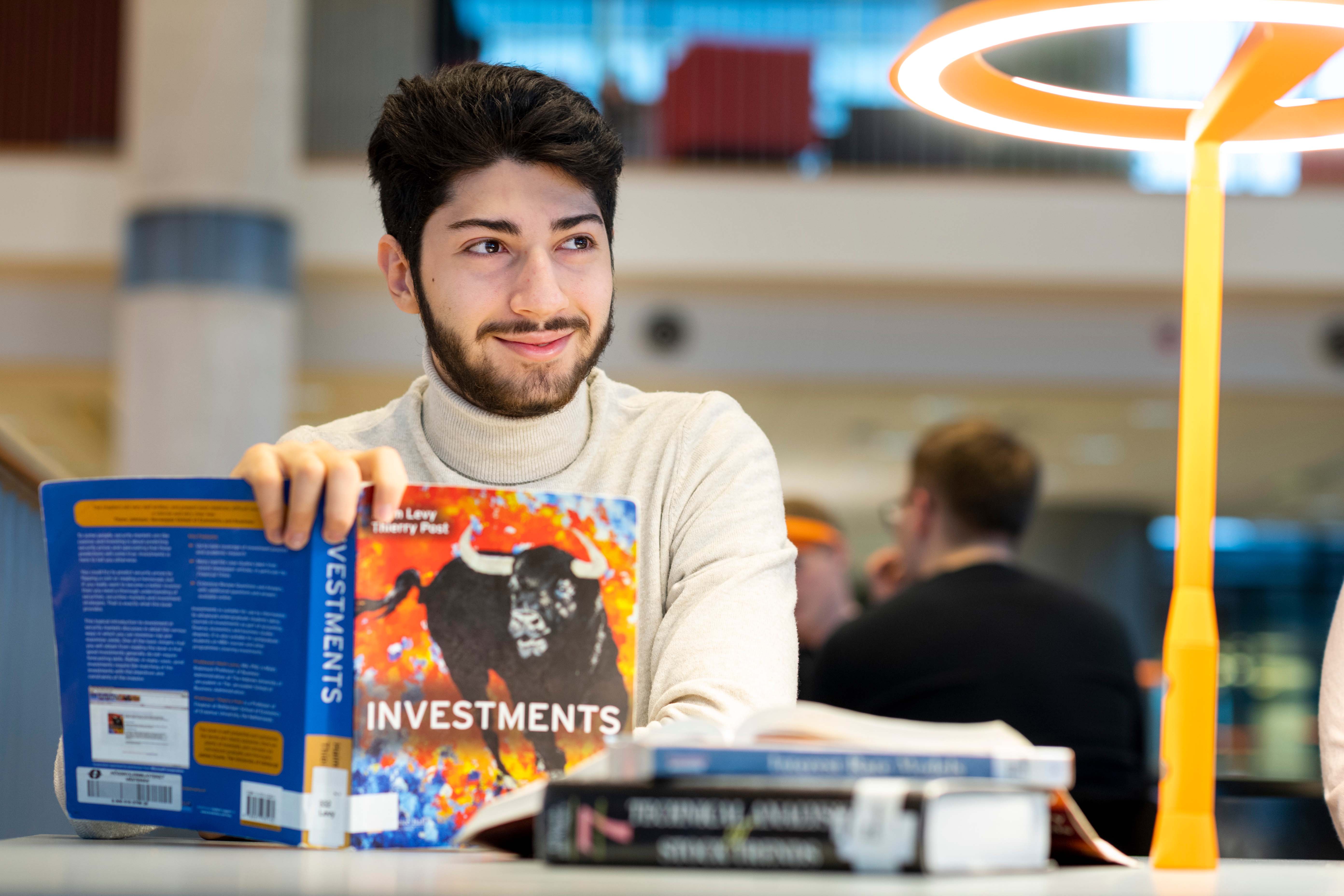 Student from Analytical finance holding a book